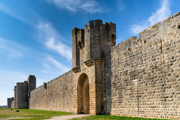 view of the historic city walls surrounding the Camargue village of Aigues-Mortes - obrazy, fototapety, plakaty