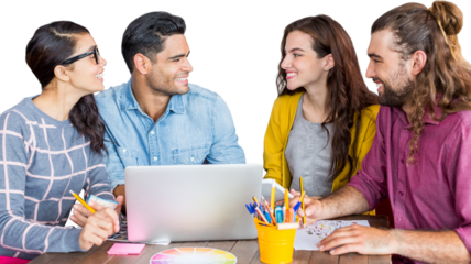 Colleagues discussing over laptop while sitting at desk
