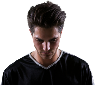 Upset football player looking down - Powered by Adobe