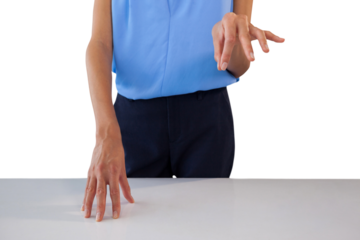 Mid section of businesswoman holding something at table