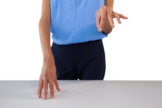 Mid section of businesswoman holding something at table