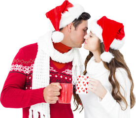 Happy couple with santa hats holding mug and kissing