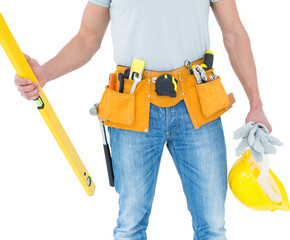 Repairman holding spirit level and hardhat