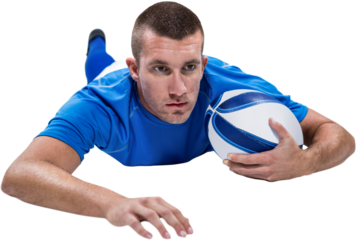 Rugby player looking away while lying in front with ball