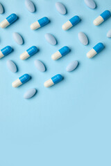 Different pills on blue background