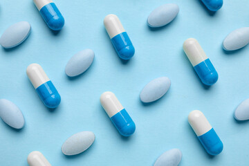 Different pills on blue background