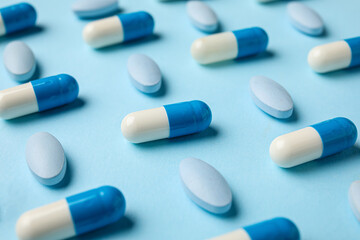 Different pills on blue background, closeup