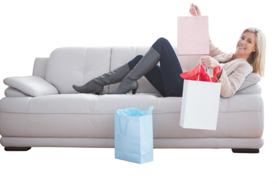 Woman lying on the couch holding shopping bags - Powered by Adobe