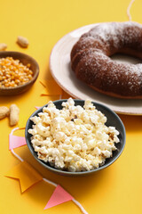Traditional food for Festa Junina (June Festival) on yellow background, closeup