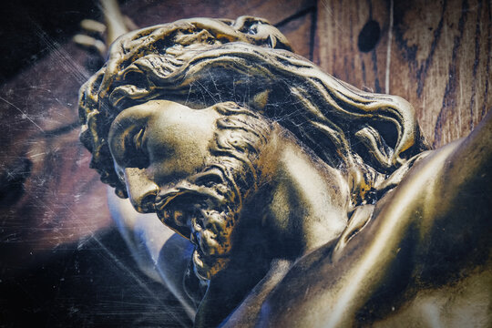 Retro styled image of an ancient statue of the crucifixion of Jesus Christ.