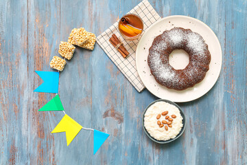 Frame made of traditional food and flags for Festa Junina (June Festival) on color wooden background