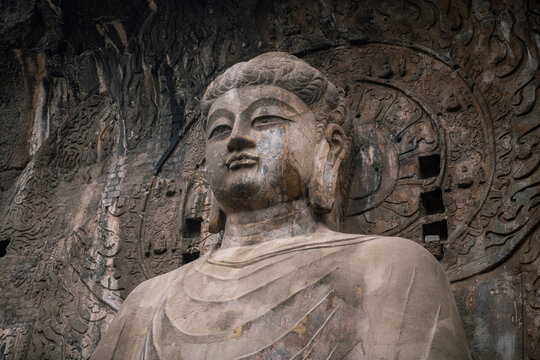 Carved Buddha images at Longmen Caves, Dragon Gate Grottoes, dating from the 6th to 8th Centuries, UNESCO World Heritage Site, Henan Province, China, Asia. Close up on Buddha face