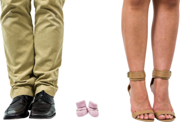 Close-up of man and woman amidst baby shoes