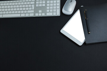 Keyboard, mouse, digital tablet, pen and organizer on black background