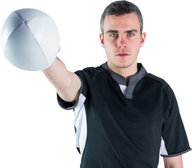 Portrait of serious rugby player holding ball