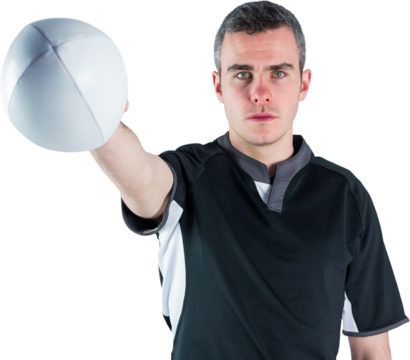 Portrait of serious rugby player holding ball