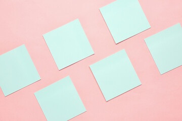 Blue sticky notes on pink background