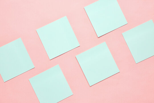 Blue sticky notes on pink background