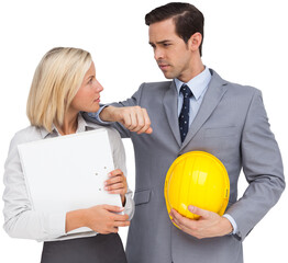Architects with plans and hard hat looking at each other