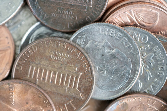 Macro image of U.S. coins with the focus on a dime and penny.