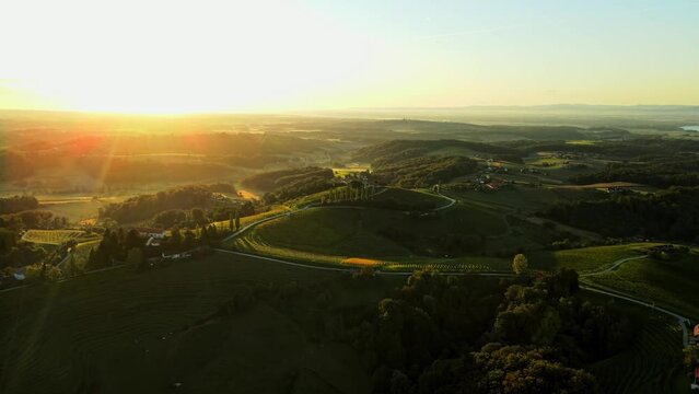 Aerial drone 4K footage of Prlekija in the morning during sunrise. Prlekija is a picturesque region in northeastern Slovenia known for its rolling hills, lush vineyards, and rich cultural heritage.