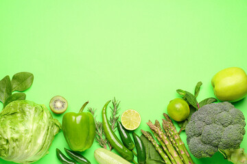 Composition with different fresh vegetables and fruits on green background