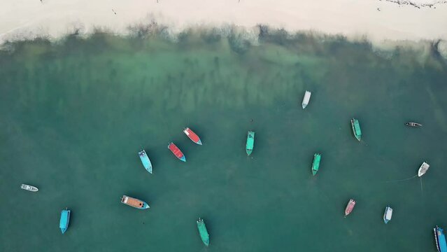 Boats at Watamu coastal, white sandy beach in Kenya, popular travel exotic destination, Africa. drone top down view