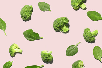 Composition with broccoli and spinach on pink background