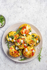 Fototapeta na wymiar Delicious egg muffins with pepper, feta cheese and spinach