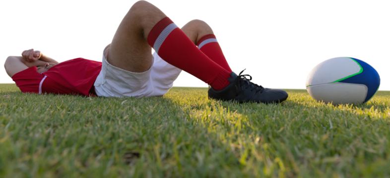 Rugby player lying on the field. - Powered by Adobe