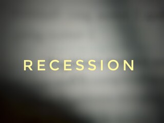 Text "Recession", background blur. Economic concept.