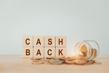 CASH BACK text on wooden cube with blurred coins and bottle for business and finance concept