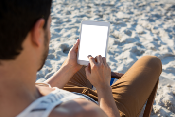 High angle view of man using digital tablet at beach