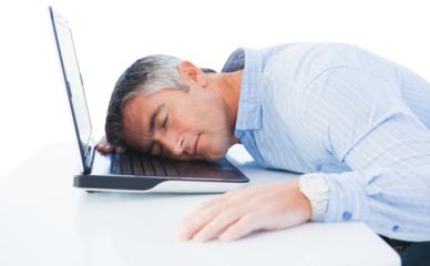 Tired businessman resting head on laptop at desk
