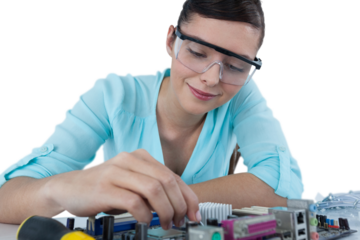 Smiling female computer engineer repairing computer motherboard
