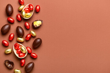 Chocolate Easter eggs and candies on brown background
