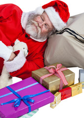 High angle view of Santa Claus sleeping beside Christmas presents