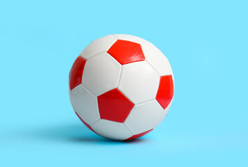Fototapeta premium Soccer ball on light blue background