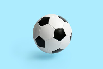 Fototapeta na wymiar Soccer ball on light blue background