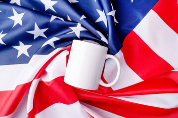 Blank white cup for mockup design over USA flag background