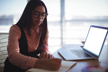 Young businesswoman working on desk at office