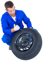 Mechanic working on tire over white background