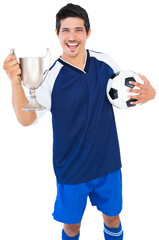 Football player holding trophy and football