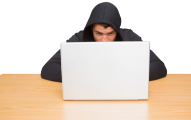 Hacker using laptop to steal identity at desk