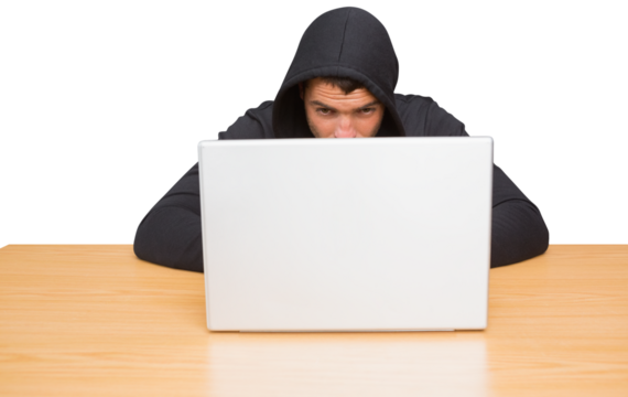 Hacker using laptop to steal identity at desk