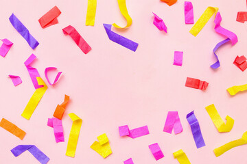 Frame made of colorful confetti on pink background