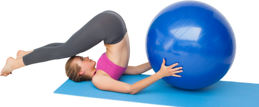 Side view of a fit woman exercising with fitness ball