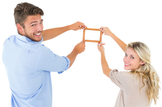 Attractive young couple hanging a frame