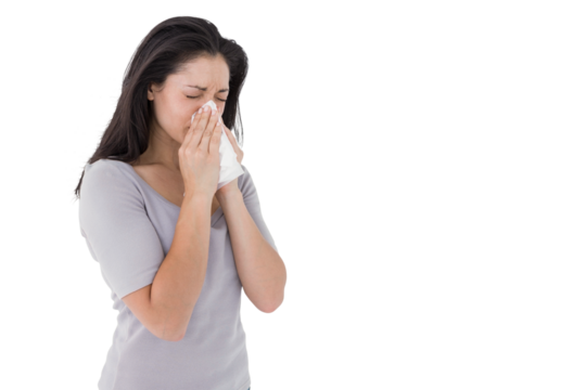 Sick brunette blowing her nose