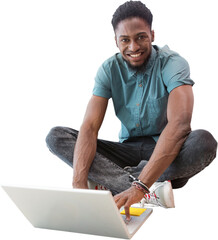 Portrait of smiling male university student using laptop